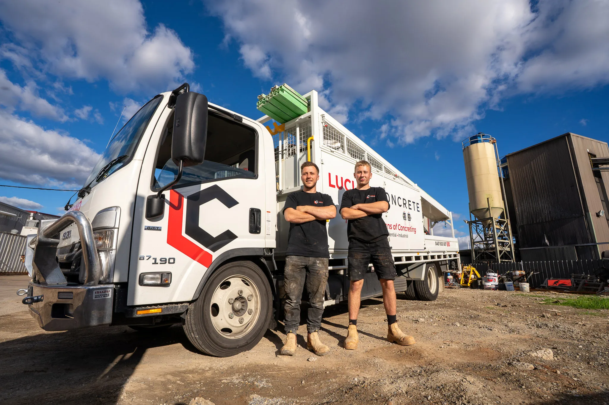 Two Luciano concrete team members in front a Luciano Concrete truck.