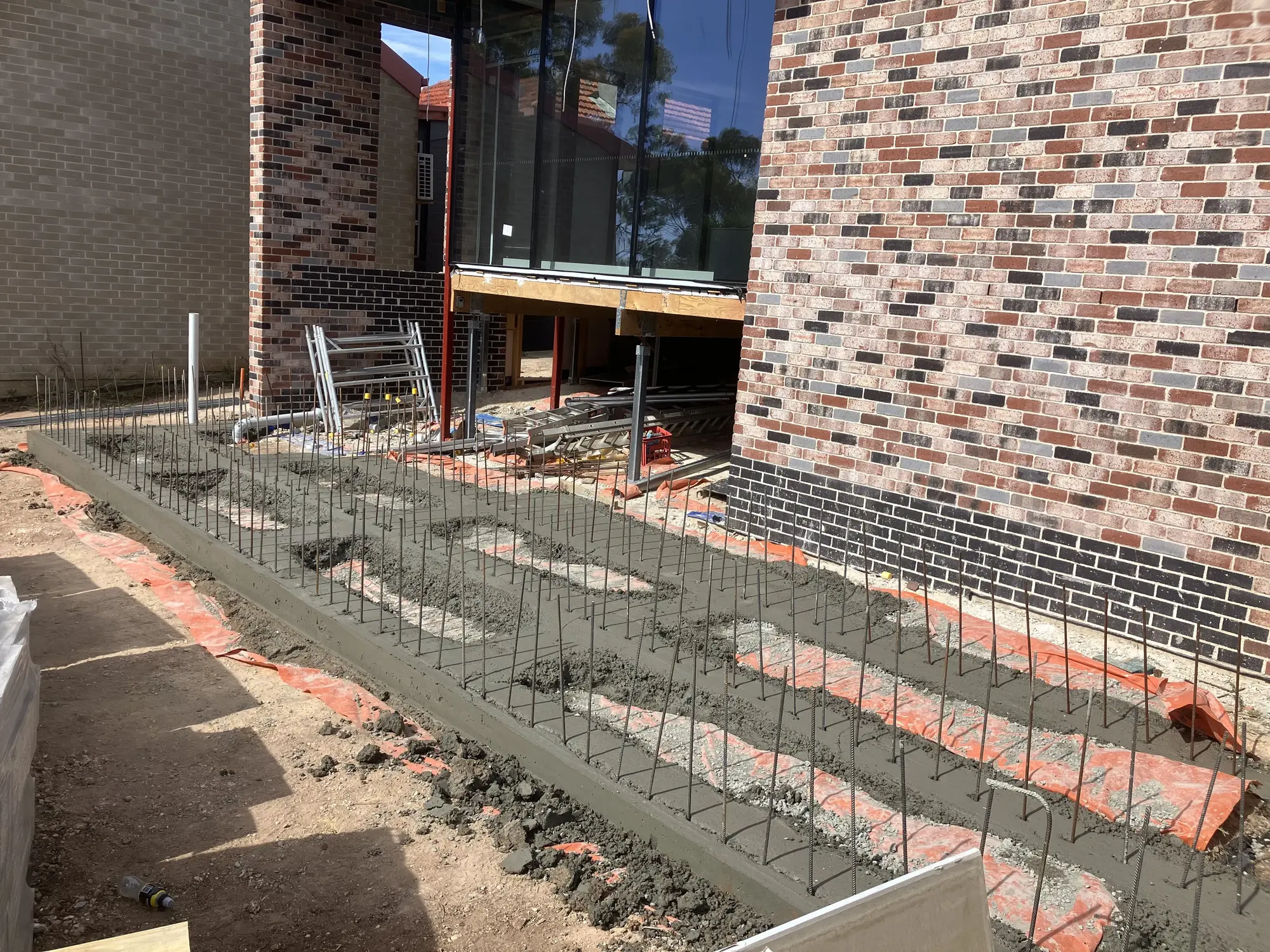 Concrete site works besides a building.