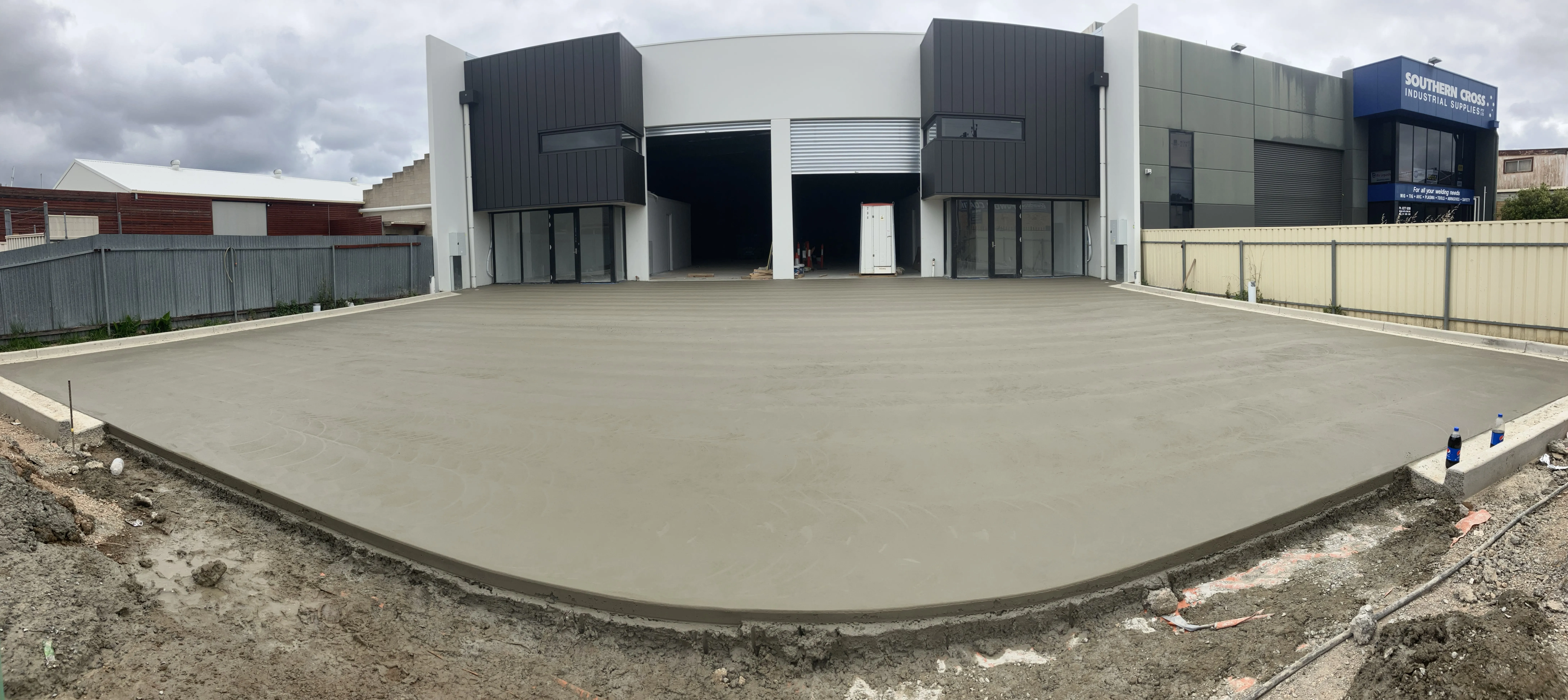 Large concrete section in front of two buildings